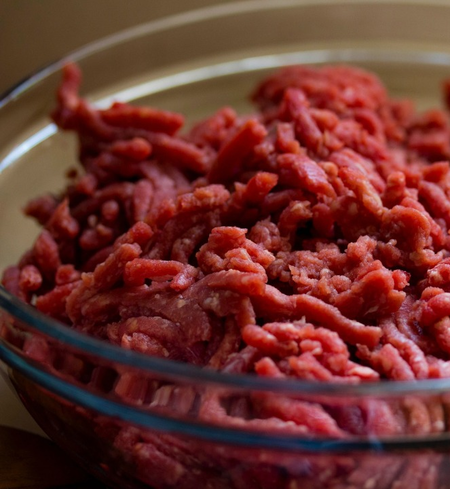 A bowl of raw ground beef.