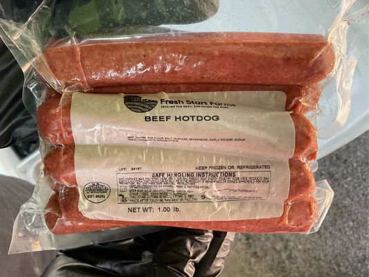 Packaged all-beef hotdogs in a plastic bag with the brand 'Fresh Start Farms' labeled on the packaging.
